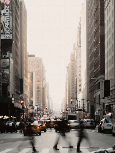 new york people walking near road between high-rise building during daytime car